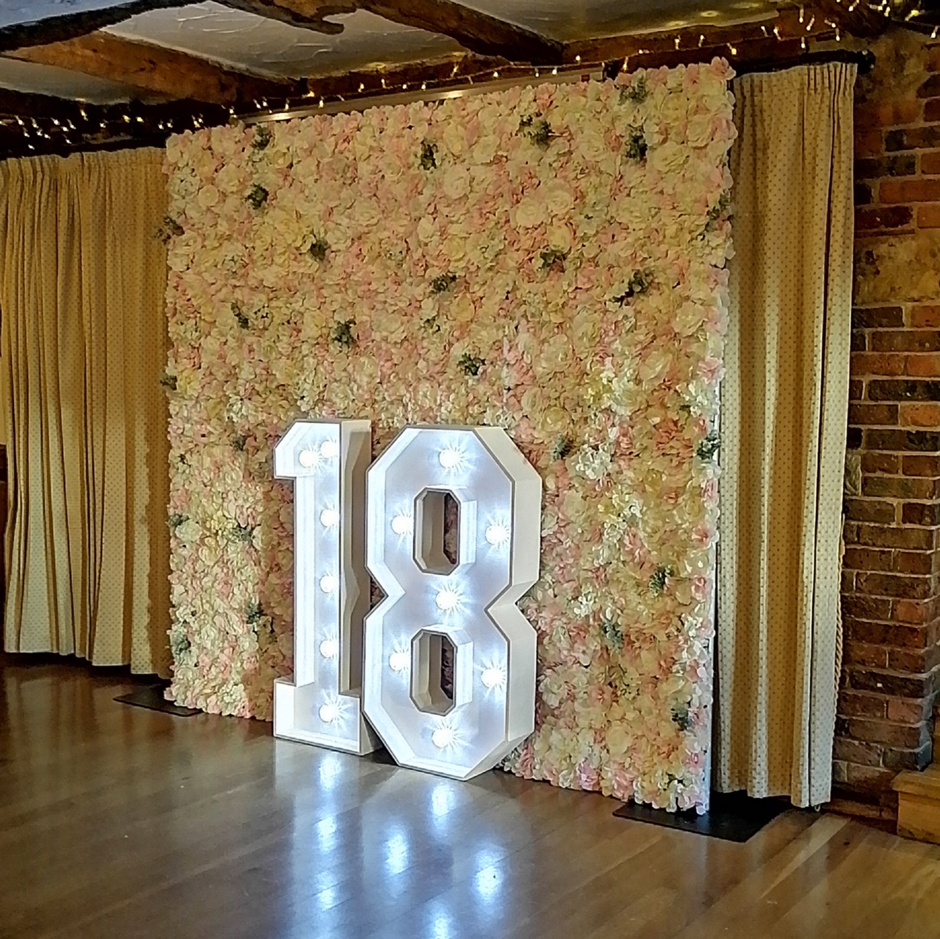 Pink and white flower wall with added greenery and light up 18